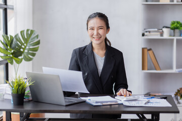 Business Asian woman working at office with documents on his desk, doing planning analyzing the financial report, business plan investment, finance analysis concept