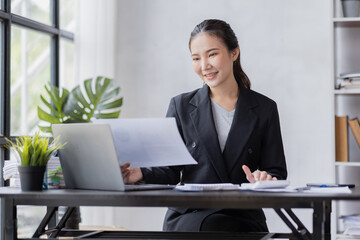 Business Asian woman working at office with documents on his desk, doing planning analyzing the financial report, business plan investment, finance analysis concept