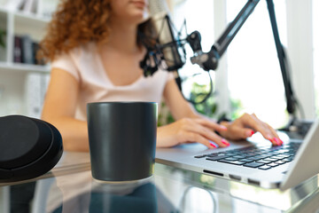Close up of a woman recording a podcast in a studio