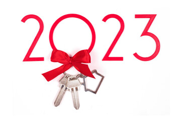 background 2023 New year and Christmas. Banner with keys and keychain. Real estate purchase concept. Sale, rent. Get the keys to the apartment as a gift