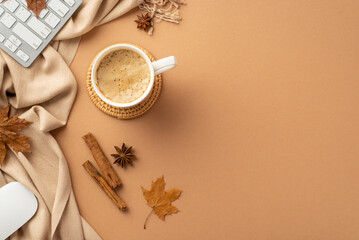 Autumn business concept. Top view photo of cup of frothy coffee rattan serving mat computer mouse keyboard yellow maple leaves cinnamon sticks anise scarf on isolated beige background with copyspace