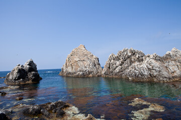 Ocean waves and strange rocks on the horizon