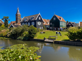 View of beautiful and traditional small Dutch town Marken with wooden houses located on former island in North Holland, Netherlands