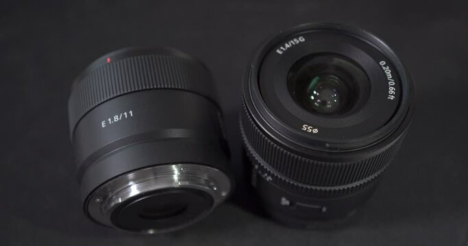 2 Sony apsc lenses E 11mm and 15mm  black background and light reflection