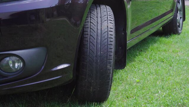 summer tire for a car,close-up of a car wheel on the grass standing in the yard