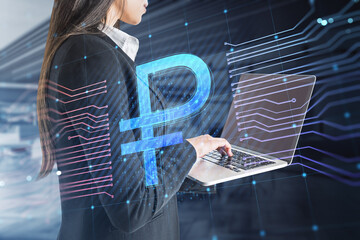 Close up of businesswoman hands using laptop with creative glowing Russian ruble circuit hologram on blurry office interior background. Digital money and online banking concept. Double exposure.