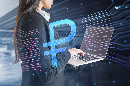 Close up of businesswoman hands using laptop with creative glowing Russian ruble circuit hologram on blurry office interior background. Digital money and online banking concept. Double exposure.