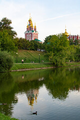 Fototapeta na wymiar Moscow, Russia - August 2, 2022 : Novodevichy Monastery. The Cathedral in honor of the Smolensk icon of the Mother of God and the Church of the Intercession of the Most Holy Theotokos
