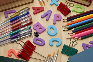 letters books pencils fountain pens brushes stationery clips on the table concept education business science