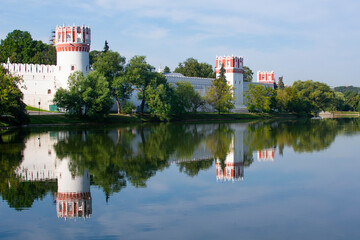 Fototapeta na wymiar Novodevichy Monastery. dicorbe walls, towers with loopholes are made of brick with white stone trim.