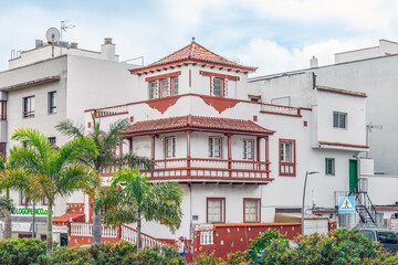 Fototapeta premium San Cristobal de La Laguna, Spain - November 24, 2021: Cityscape with a beautiful old building on the corner of Calle Alfonso XIII street in La Laguna town. Amazing architecture of the Canary Islands