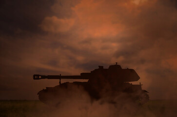 Fototapeta premium Silhouette of tank on battlefield in night