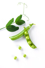 Ripe pea pods with green leaves on a white background.