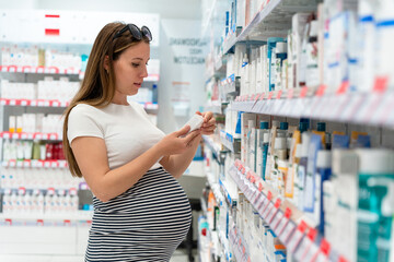 Pharmacy counter pregnant woman. Happy pregnancy girl customer in retail health drugstore. Pregnancy, medicine health care concept.