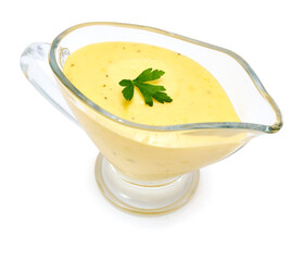 Tasty yellow hollandaise sauce in glass bowl gravy boat isolated on white background