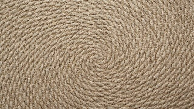 Jute braided spiral rug texture background clos-up. Macro brown vintage jute texture.