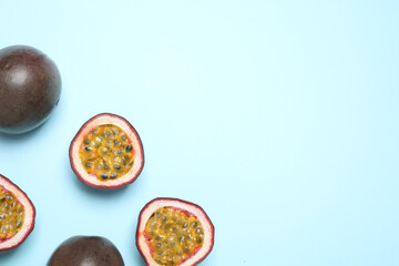 Fresh ripe passion fruits (maracuyas) on light background, flat lay. Space for text