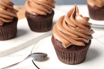 Delicious fresh chocolate cupcake on table, closeup