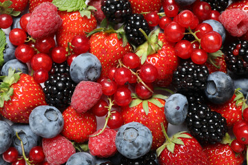 Mix of fresh delicious berries as background, top view
