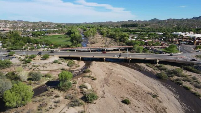 4K Drove Flyover Hassayampa river in Wickenburg Arizona on a sunny day clouds blue sky and traffic going over the bridge