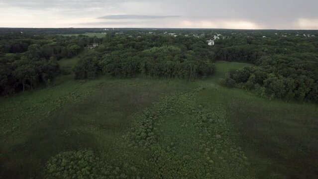 Drone footage of Chain o Lakes Camping site. Aerial view of rural fields and forest.