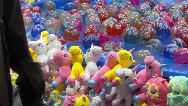 Catching the floating balls on the water to win a plush toy, popular carnival games at Ekka Brisbane Showgrounds, Royal Queensland Show, Australia.