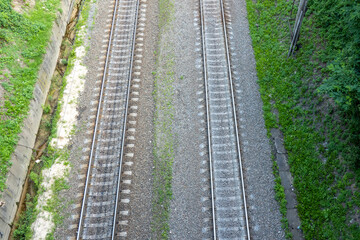 Fototapeta na wymiar railway tracks on the road, view from above on the railway road, travelling, direction of way 