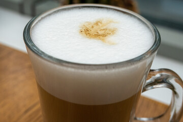 close up of white frothy foam in the cup of latte. Softness of drink. Breakfast time in cafe 