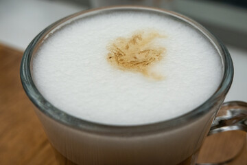 close up of white frothy foam in the cup of latte. Softness of drink. Breakfast time in cafe 