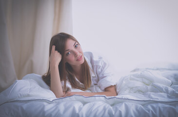 Portrait of beautiful woman on bed at bedroom