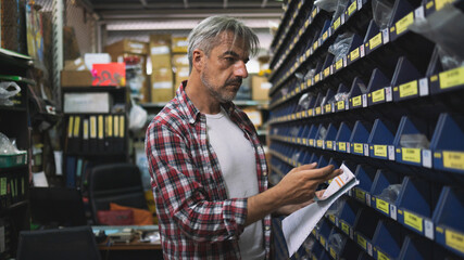 A person sells tools and equipment at a construction store.Warehouse Shelves, Business Tools...