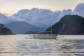 Caramoan Island National Park Sunrise Sunset with fishing boat in Bicol Region, Philippines  