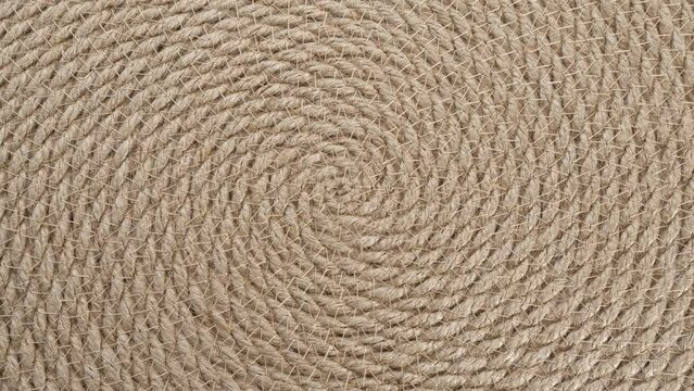 Jute braided spiral rug texture background clos-up. Macro brown vintage jute texture.