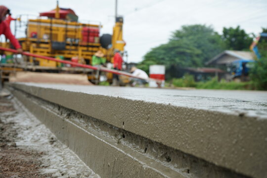 Blurred image of concrete road construction with heavy machinery