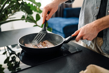 Young man making lunch while spending time at home