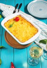 Delicious homemade italian Lasagna with bachamel sauce in the oven in a ceramic dish.