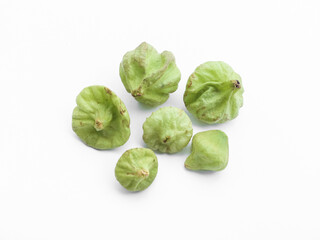 Isolated tectona grandis seeds on white background, soft and selective focus.