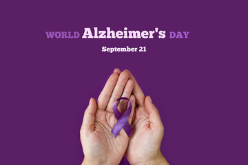 World Alzheimer's day. September 21. International Epilepsy Day. Adult hands holding purple ribbon...