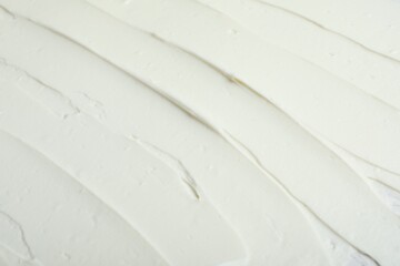 Tasty cream cheese as background, closeup view