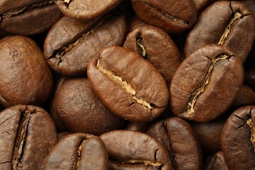 Pile of roasted coffee beans as background, closeup