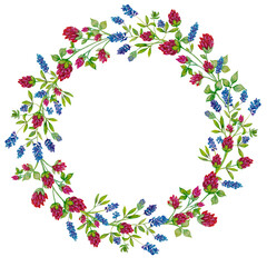 Wreath of wild flowers painted in watercolor and isolated on a white background.