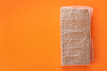 Bubbles covering the box by bubble wrap for protection product cracked on a orange background