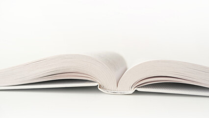 Opened white book on white background
