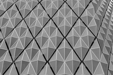 Fragment of a modern building. Abstract geometric background. Part of the facade of a skyscraper...