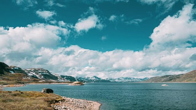 Oppland, Tyin Lake, Norway. Stones On Coast Of Beautiful Lake Tyin In Summer Day. Norwegian Nature. 4K.