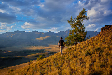 a man walking in the mountains