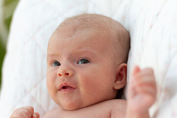 close up of an adorable newborn baby looking at her mother