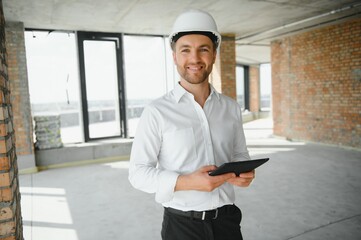 Business architect man wearing hardhat standing of a building project