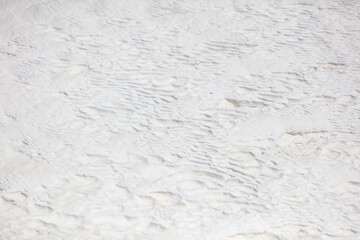 White volcanic limestone rock as background.