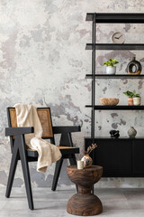 Exquisite and modern composition of living room interior with design black armchair, furnitures, decoration, pillow and elegant accessories. Concrete grunge wall.